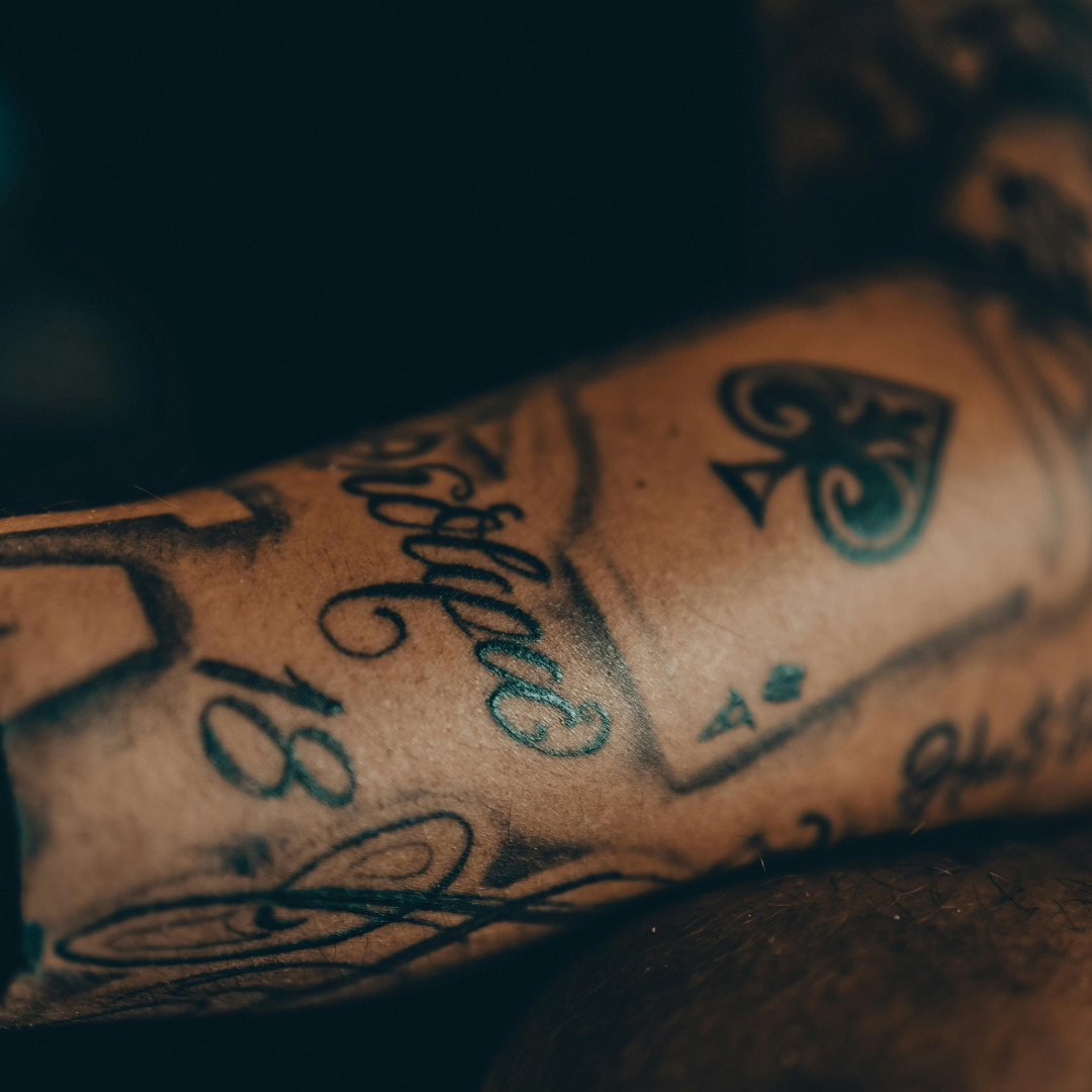 A close up of an arm covered in tattoos 